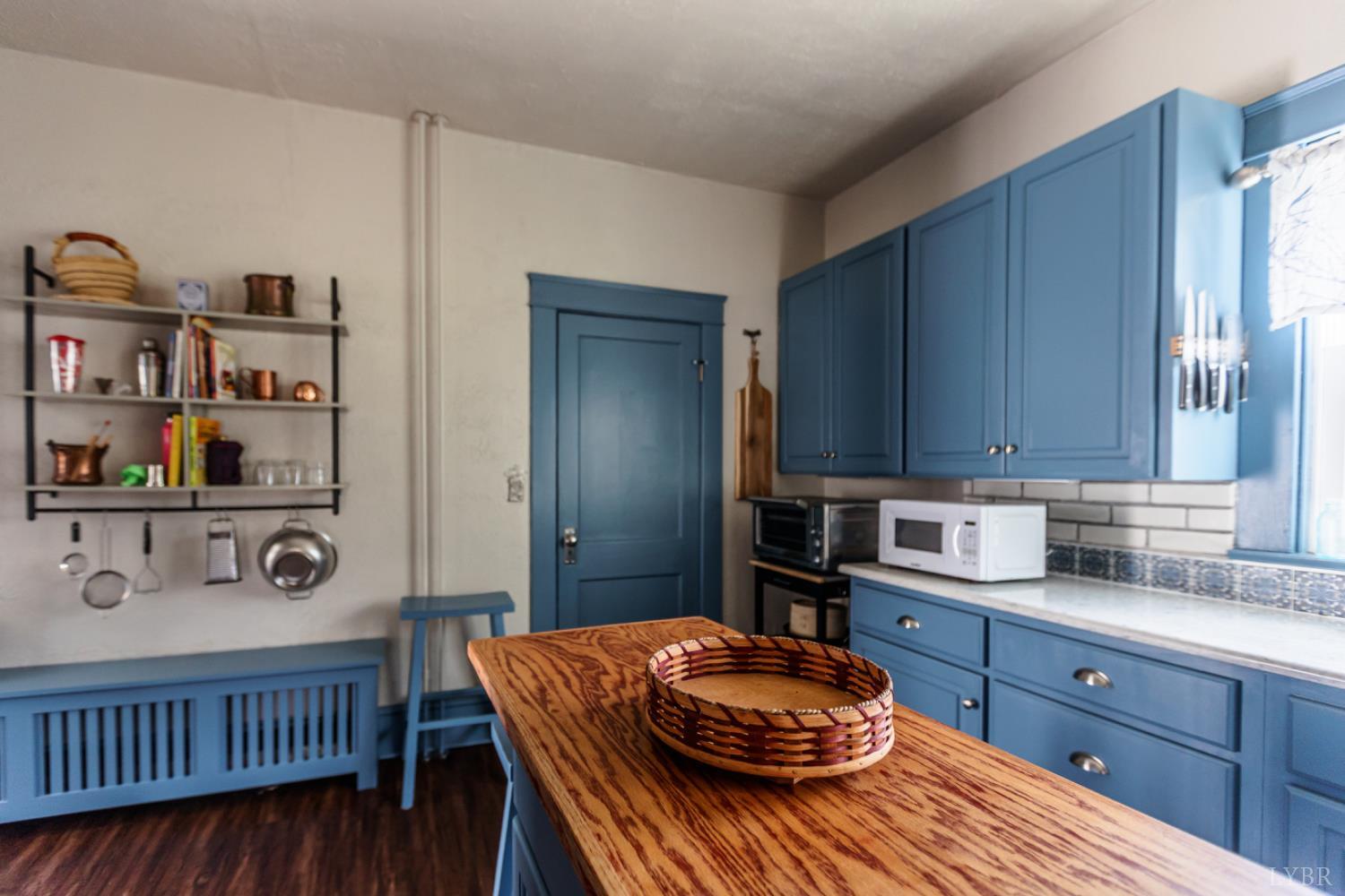 172 Pecan Street Pamplin, VA 23958 - Photo 16 of 40 a kitchen with stainless steel appliances kitchen island granite countertop a table chairs and a refrigerator