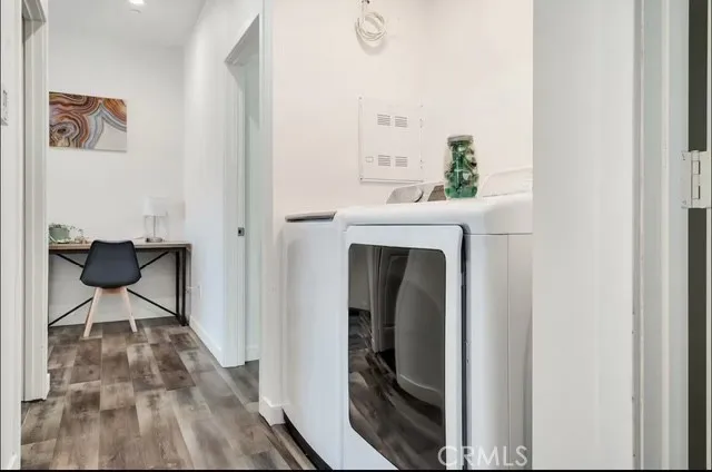 a living room with a wooden floor and furniture