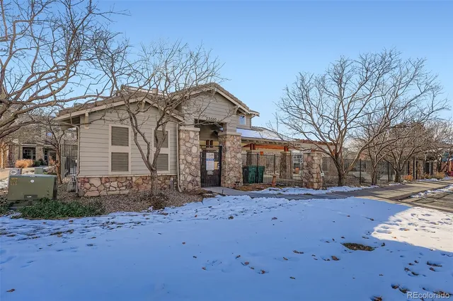 a front view of a house with a yard covered in snow