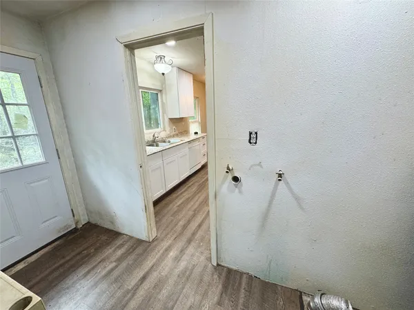a view of wooden floor and cabinet in a bathroom