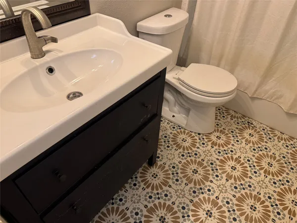 a bathroom with a sink toilet and vanity