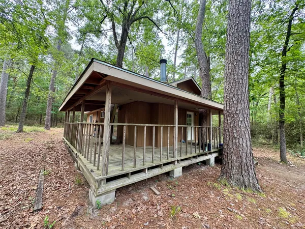 a view of a small yard with wooden deck and deck