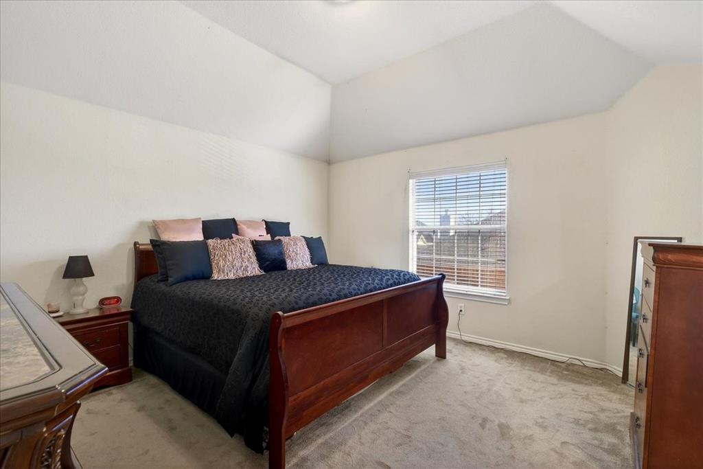 7308 Hawk Lane Sachse, TX 75048 - Photo 24 of 37 a bed sitting in a bedroom next to a window