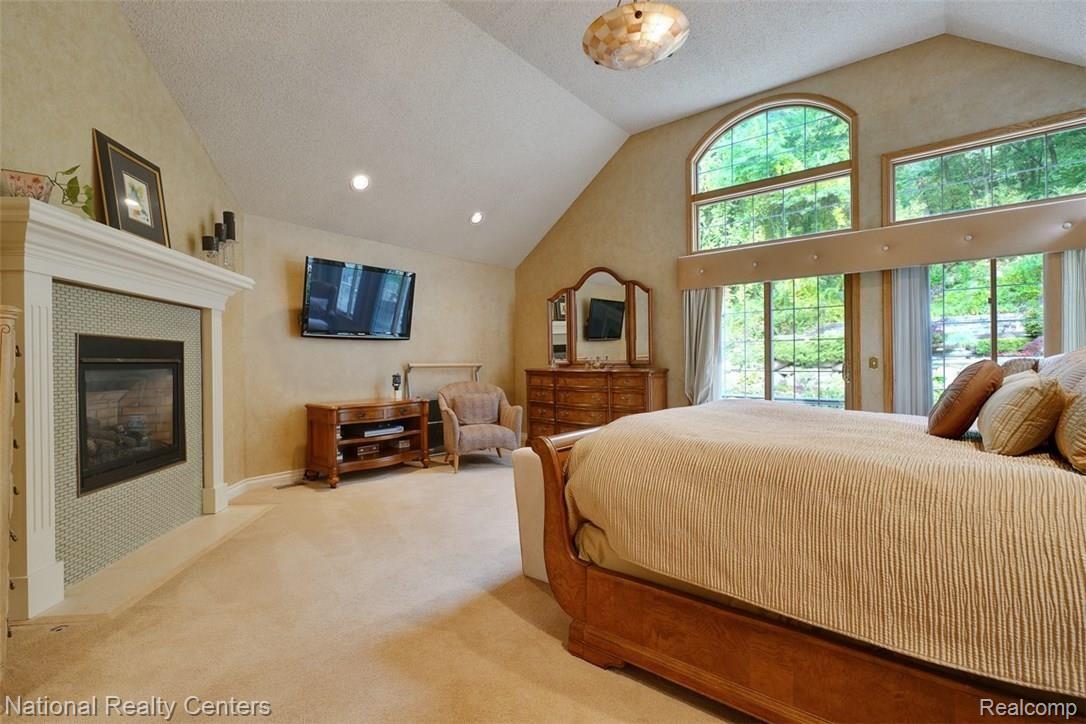 323 North Garner Road Milford, MI 48380 - Photo 25 of 56 Master bedroom with access to private back deck and fireplace
