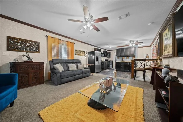 a living room with furniture and kitchen view