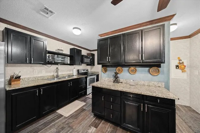 a large kitchen with a sink and dishwasher wooden cabinets