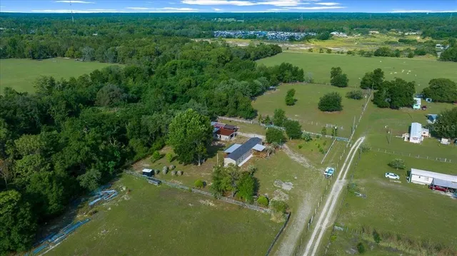 an aerial view of a houses with a yard