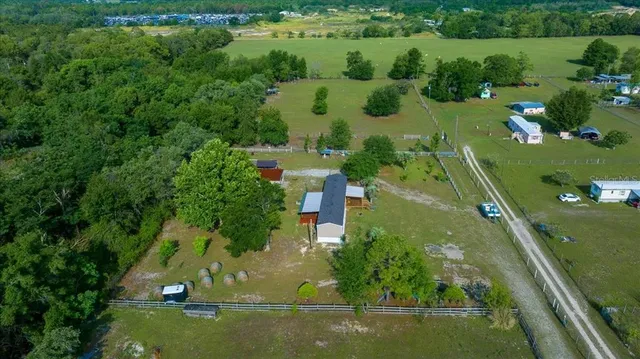 an aerial view of residential houses with outdoor space