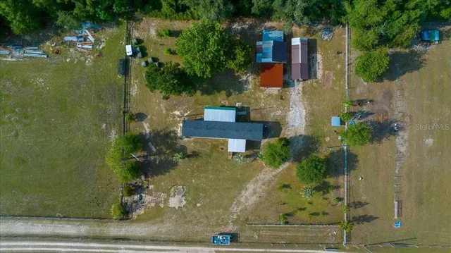 an aerial view of a house with a yard