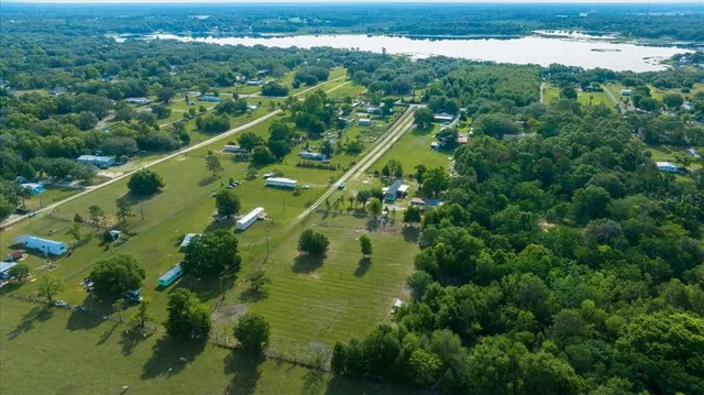 an aerial view of a pool with a yard