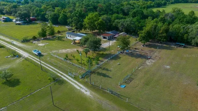 an aerial view of residential house with yard and lake view