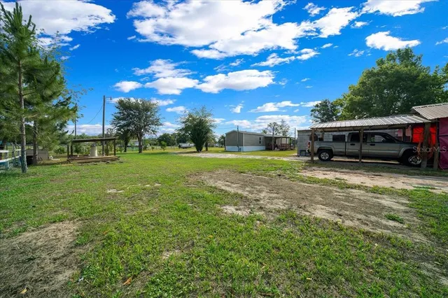 a view of a house with a big yard