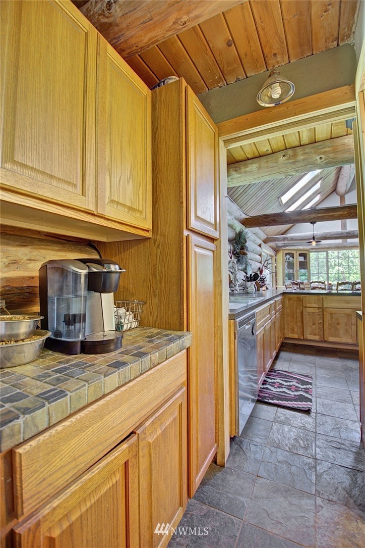 16634 Williams Lane Southwest Rochester, WA 98579 - Photo 15 of 33 a kitchen with granite countertop a sink and cabinets