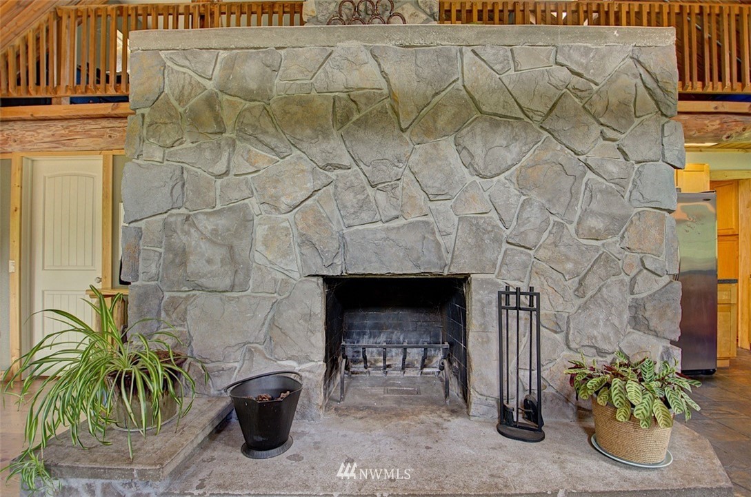 16634 Williams Lane Southwest Rochester, WA 98579 - Photo 7 of 33 a living room with a fireplace and a potted plant