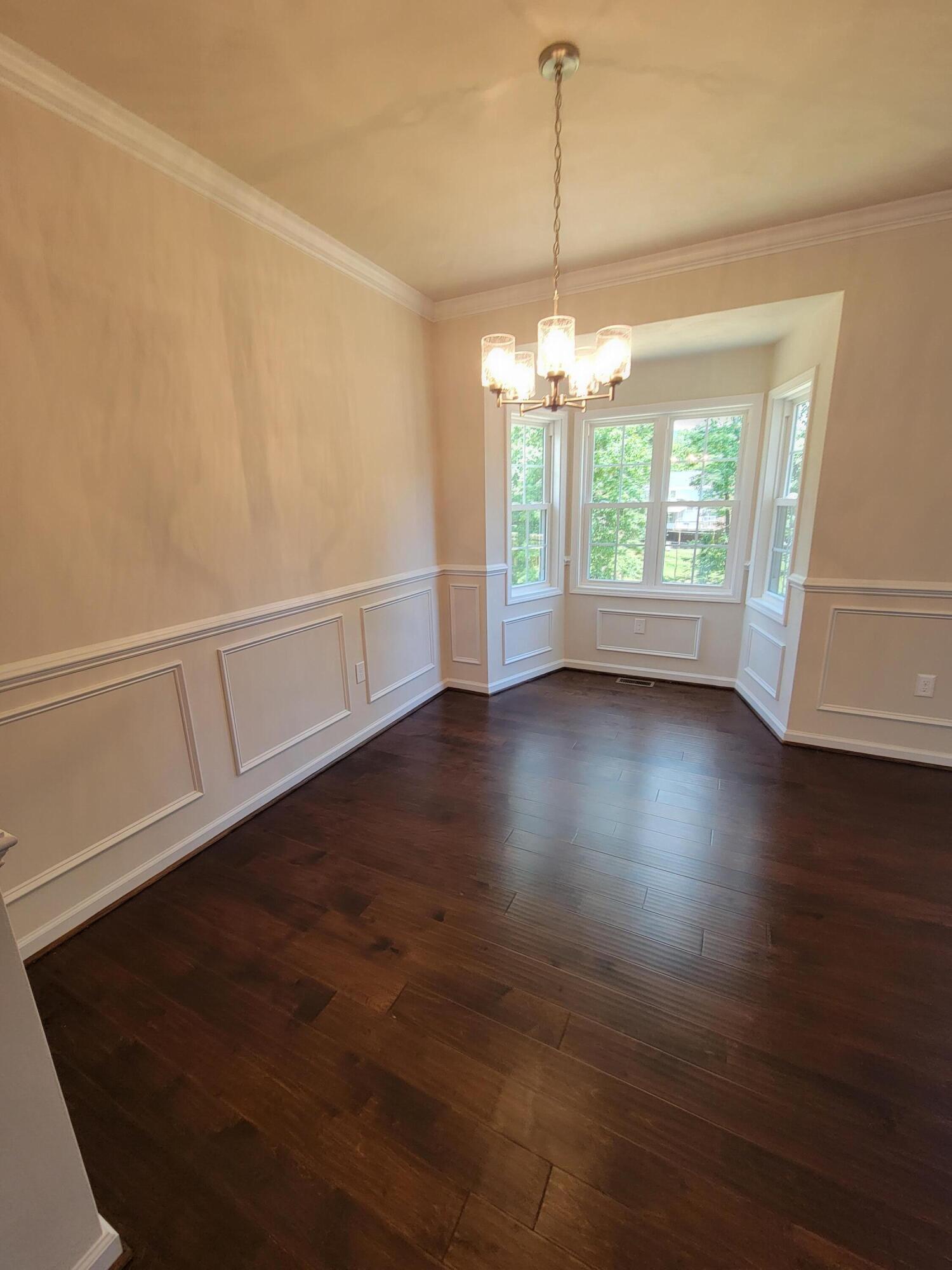 83 Upland Drive Salem, VA 24153 - Photo 4 of 9 an empty room with wooden floor and windows