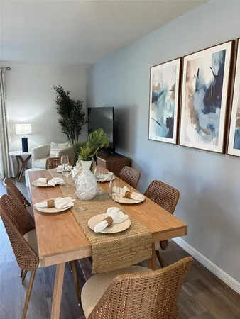 a view of a dining room with furniture and wooden floor