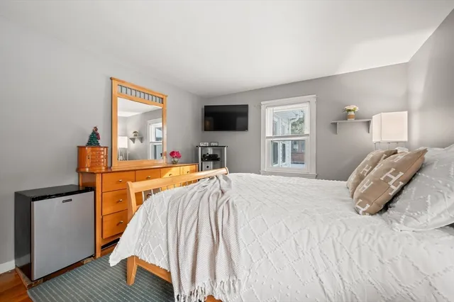 a bathroom with a sink a mirror a toilet and a window