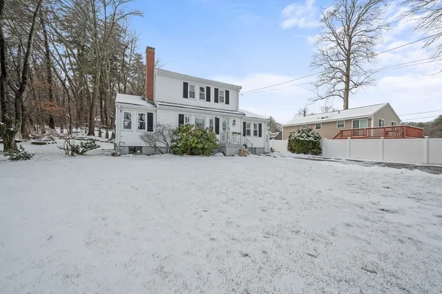 a view of a house with a snow in front of yard