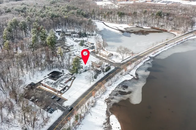 a kitchen with stainless steel appliances kitchen island granite countertop a stove a sink and a refrigerator