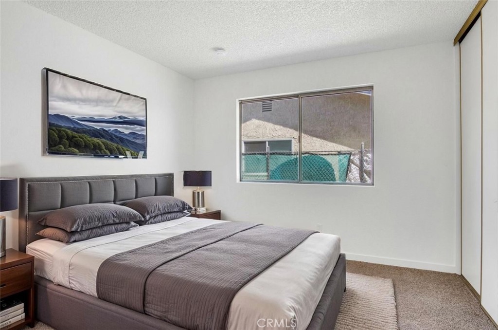 1012 Lightcap Street Lancaster, CA 93535 - Photo 13 of 33 a bedroom with a bed and a painting on the wall