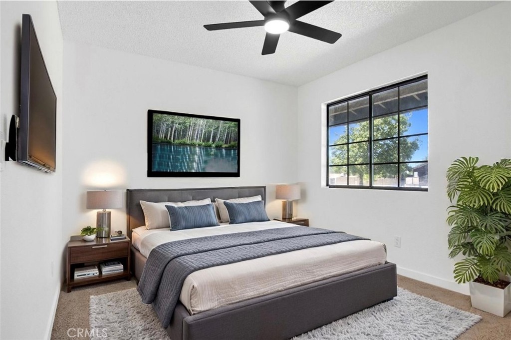 1012 Lightcap Street Lancaster, CA 93535 - Photo 15 of 33 a bedroom with a bed and a potted plant