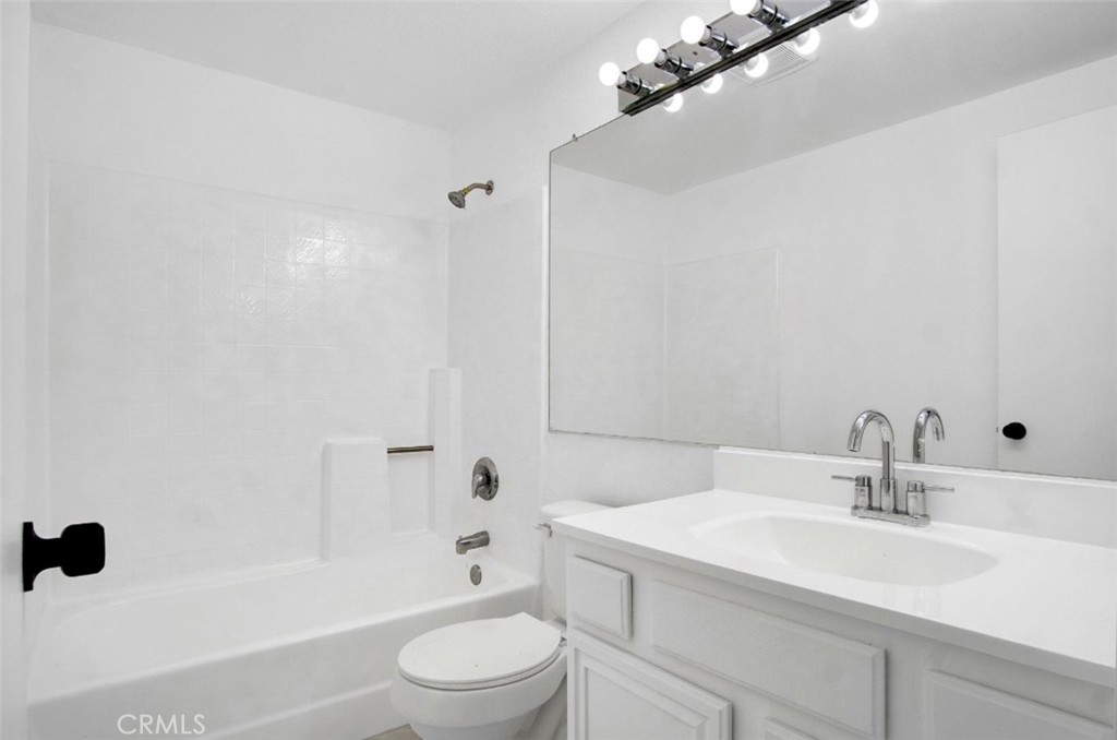 1012 Lightcap Street Lancaster, CA 93535 - Photo 17 of 33 a bathroom with a sink a toilet and shower