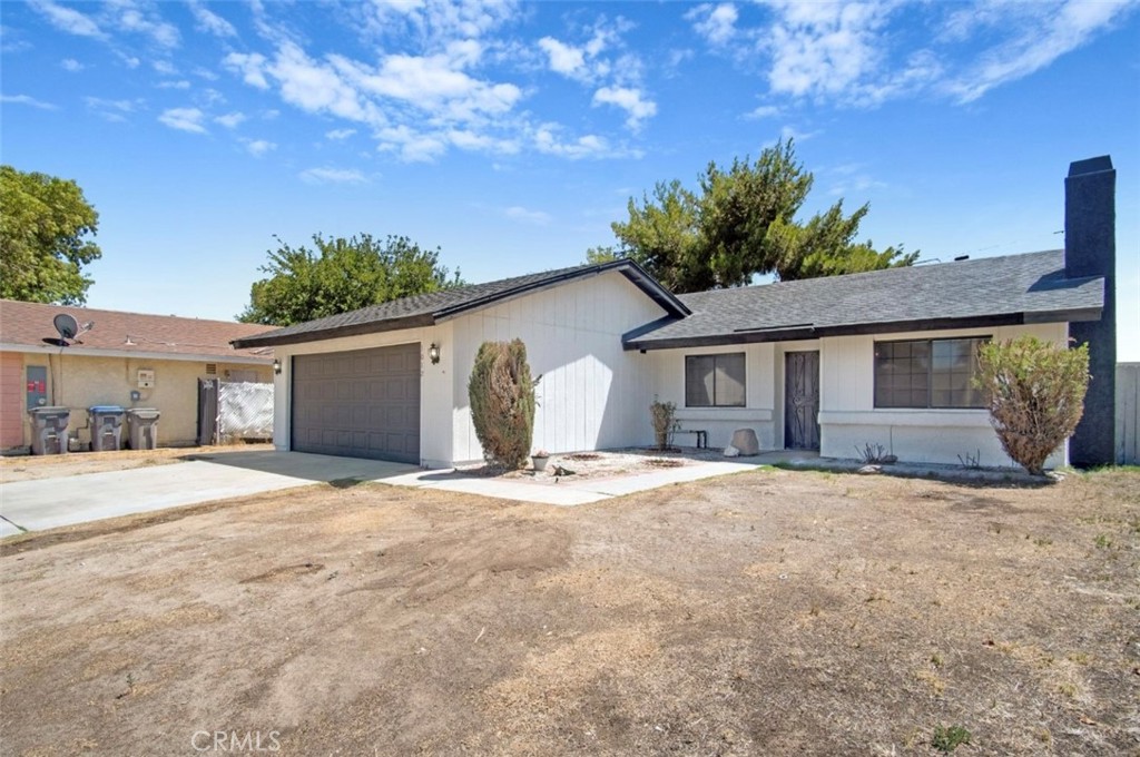 1012 Lightcap Street Lancaster, CA 93535 - Photo 3 of 33 a front view of a house with a yard and garage