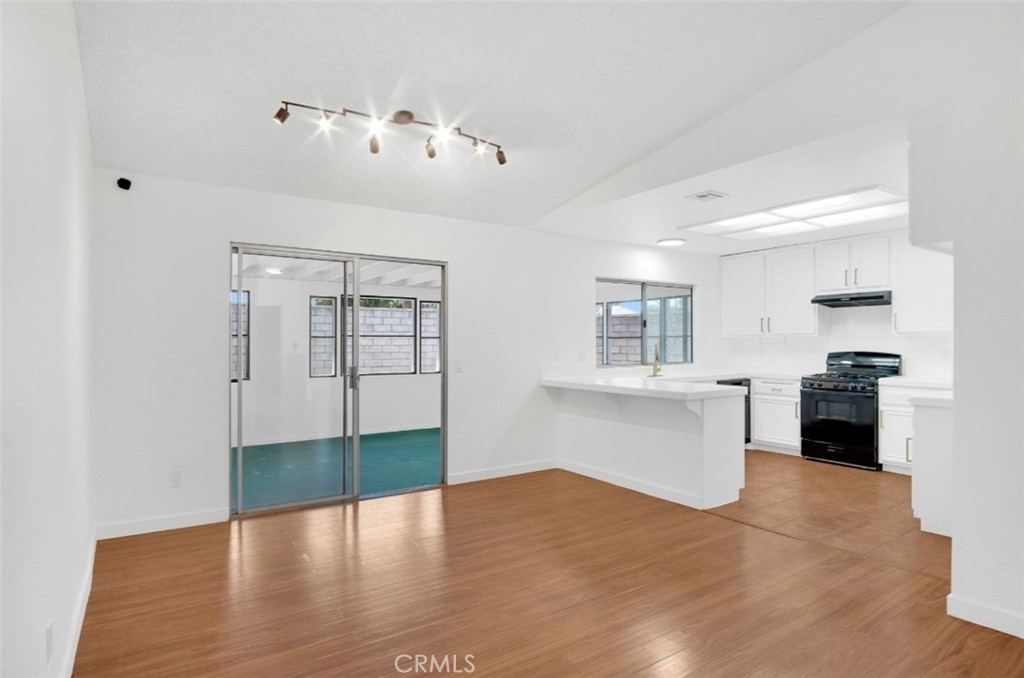1012 Lightcap Street Lancaster, CA 93535 - Photo 8 of 33 a kitchen with a refrigerator and a stove top oven