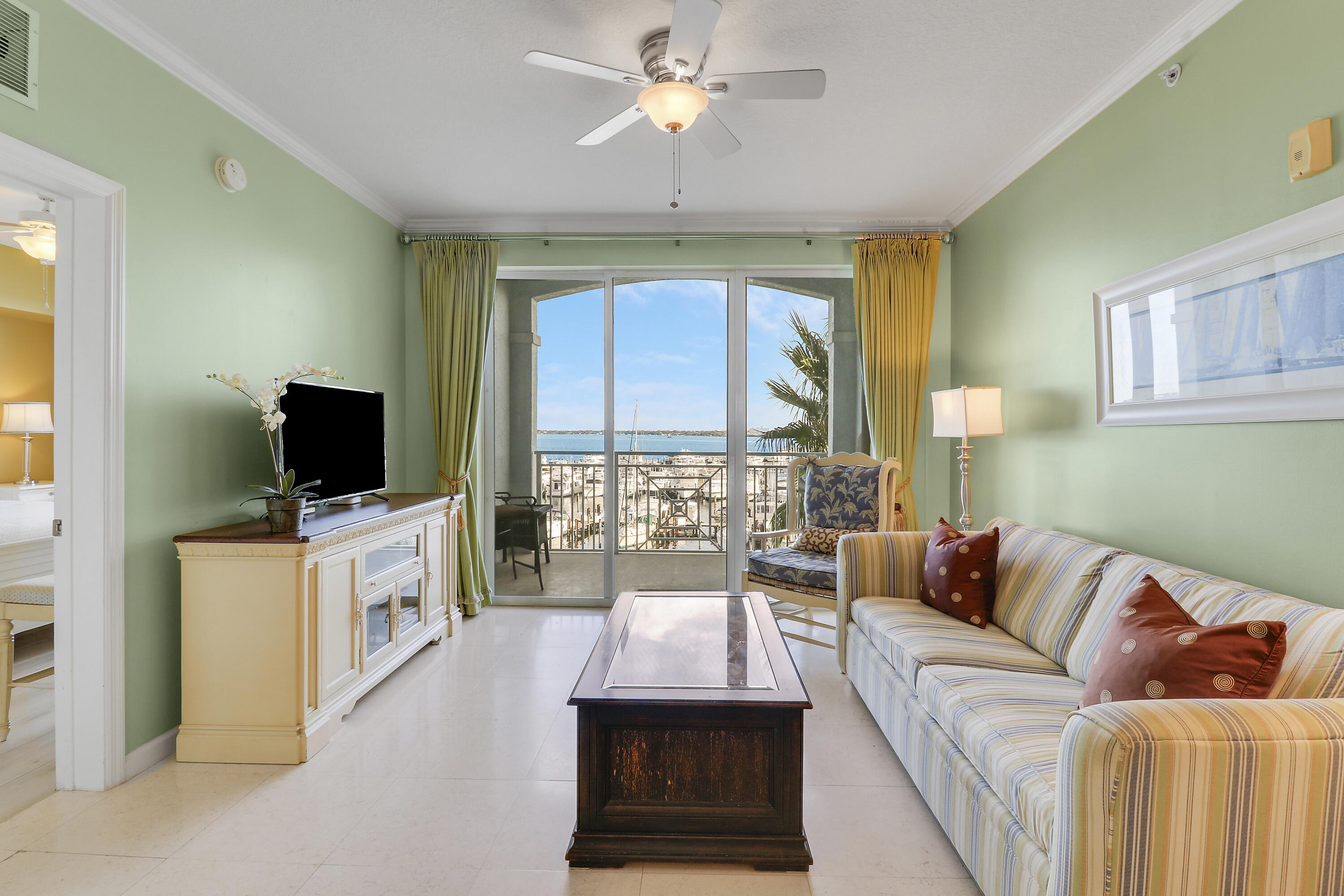875 Northwest Flagler Avenue, Unit 401 Stuart, FL 34994 - Photo 13 of 36 a living room with furniture and a flat screen tv