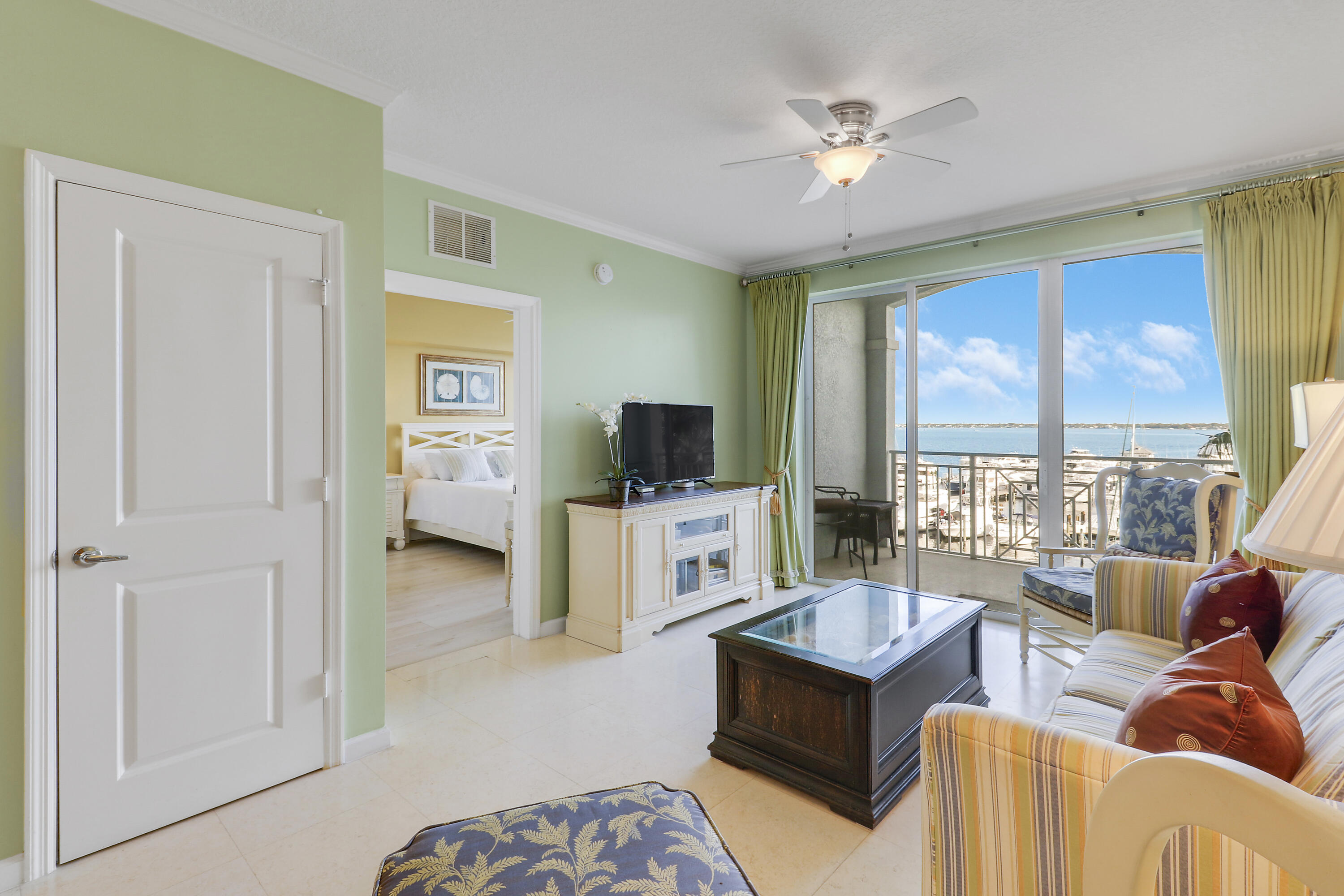 875 Northwest Flagler Avenue, Unit 401 Stuart, FL 34994 - Photo 16 of 36 a living room with furniture and a flat screen tv