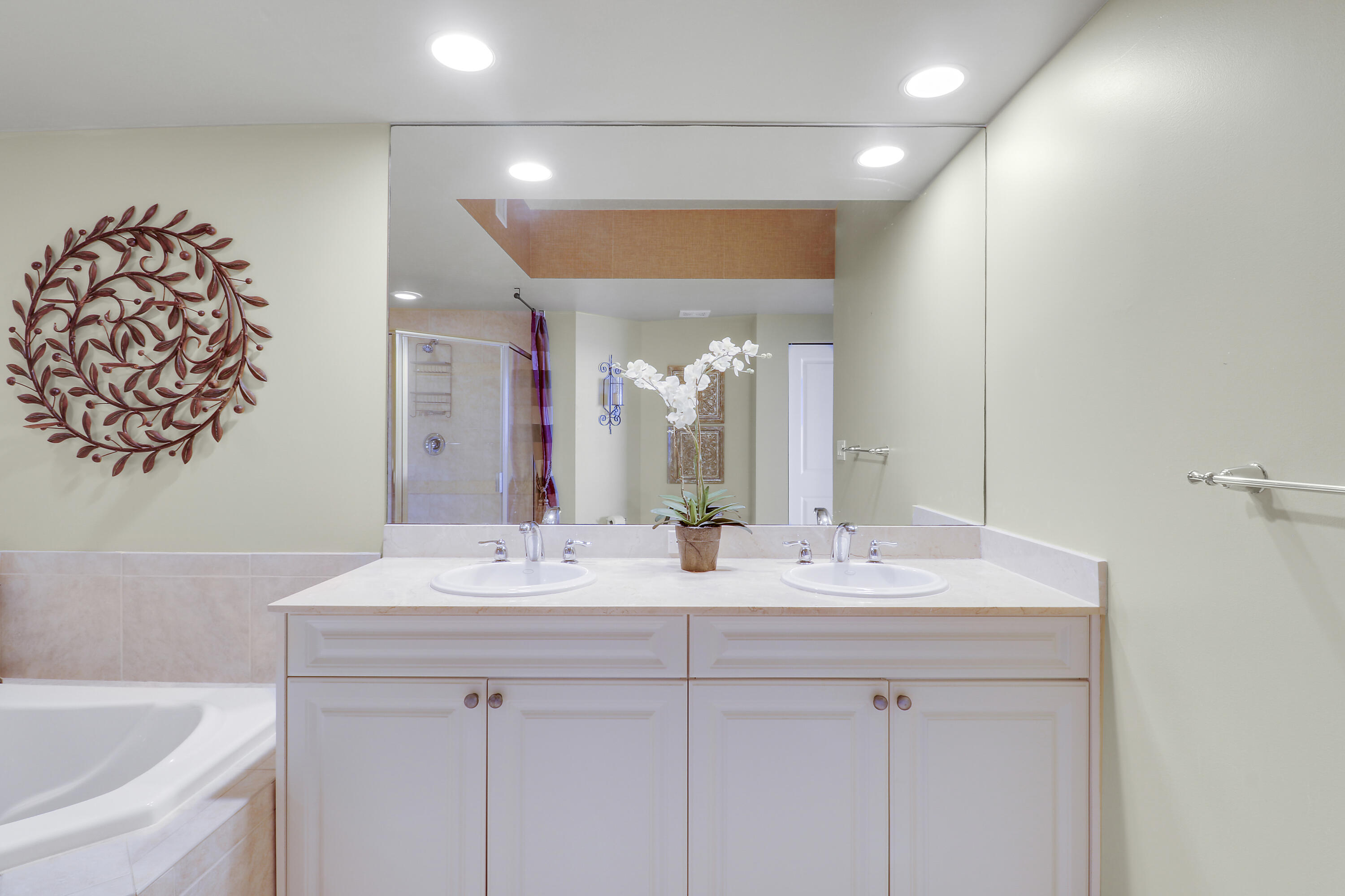 875 Northwest Flagler Avenue, Unit 401 Stuart, FL 34994 - Photo 21 of 36 a bathroom with a double vanity sink mirror and double