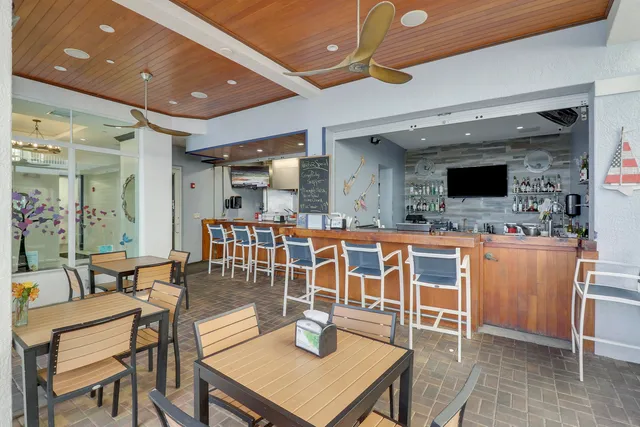 a dining room with wooden floor glass table and chairs