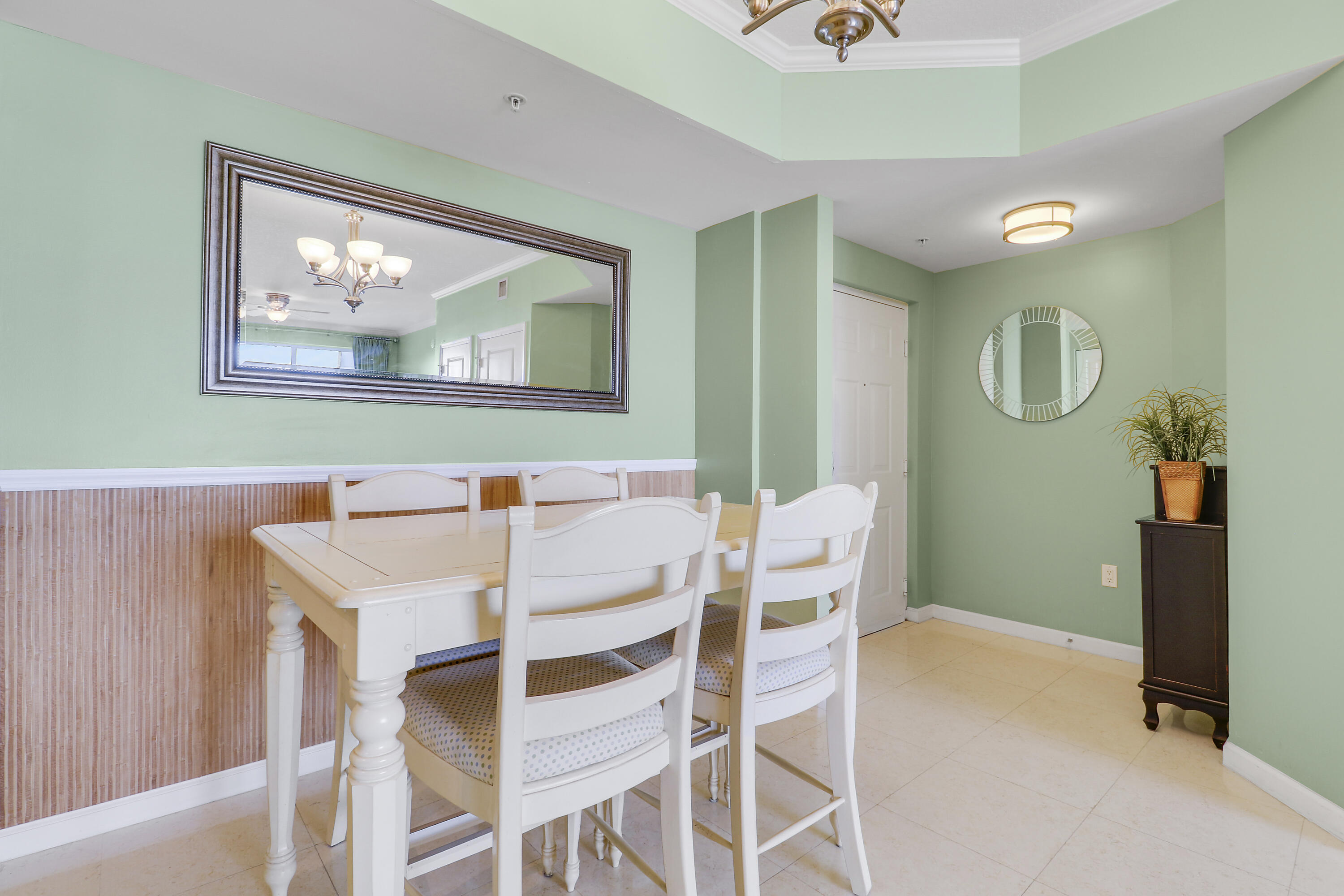 875 Northwest Flagler Avenue, Unit 401 Stuart, FL 34994 - Photo 5 of 36 a view of a dining room with furniture and chandelier