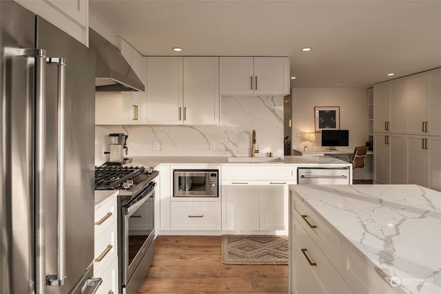 a kitchen with a sink stove and refrigerator