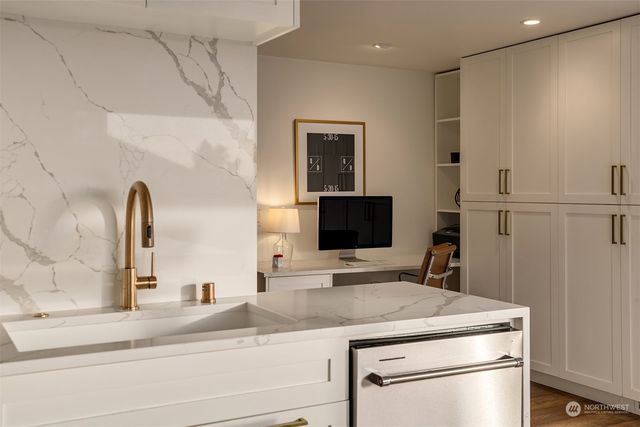 a close view of a sink and a refrigerator in a kitchen