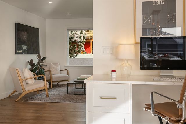 a room with a table chairs and a workspace