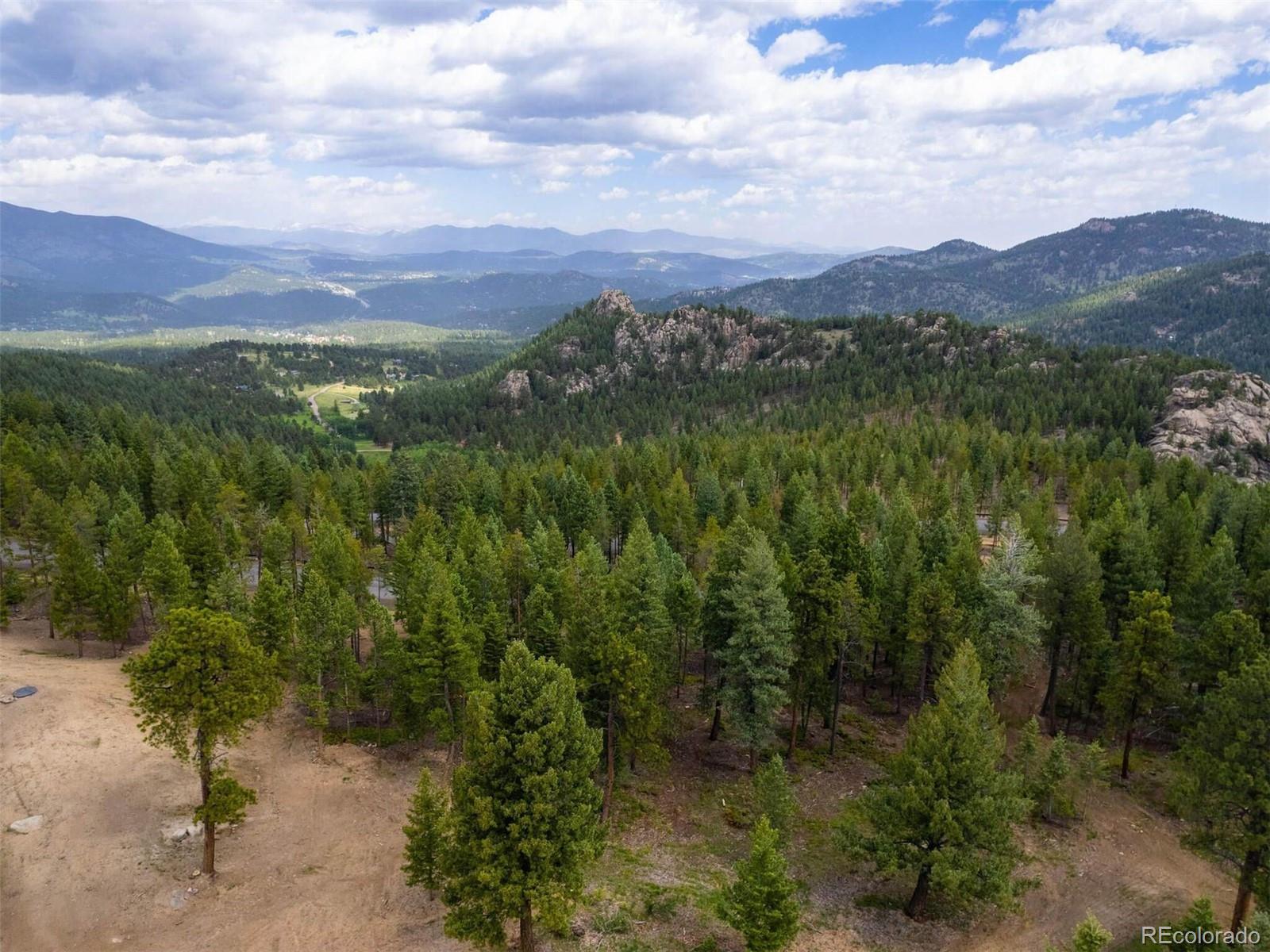 6371 Canyon Creek Road Evergreen, CO 80439 - Photo 41 of 50 a view of a lush green hillside and a houses