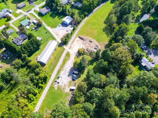 an aerial view of a residential houses with swimming pool and outdoor space