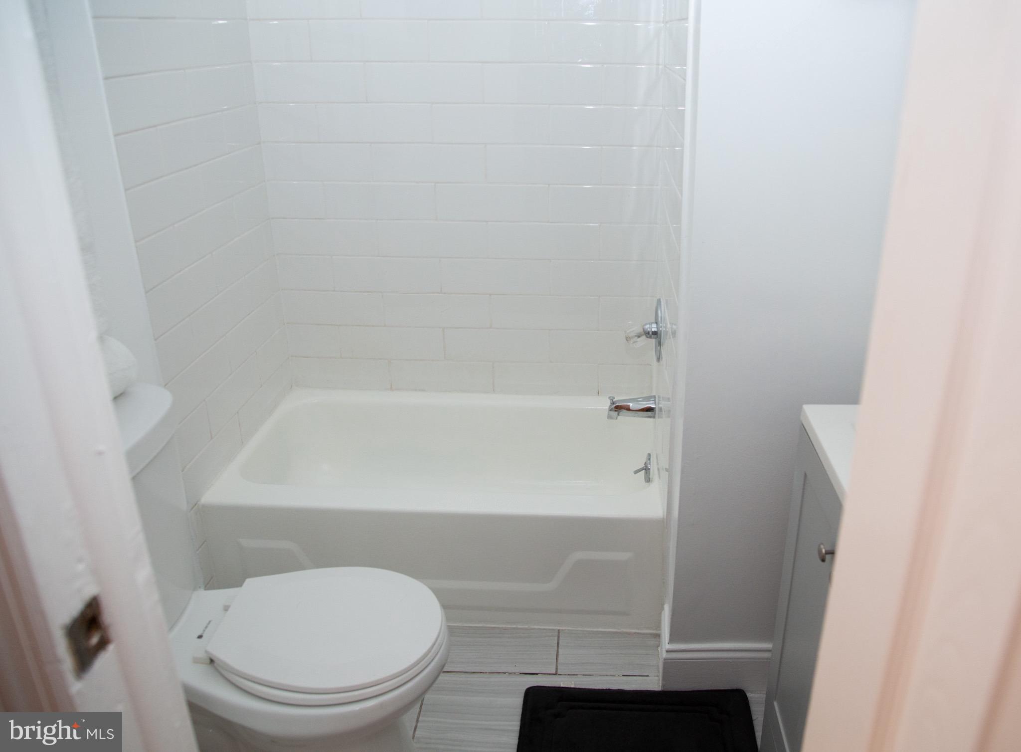 1345 1st Street Northwest, Unit 1 Washington, DC 20001 - Photo 8 of 9 Modern bathroom with clean, bright tiles.