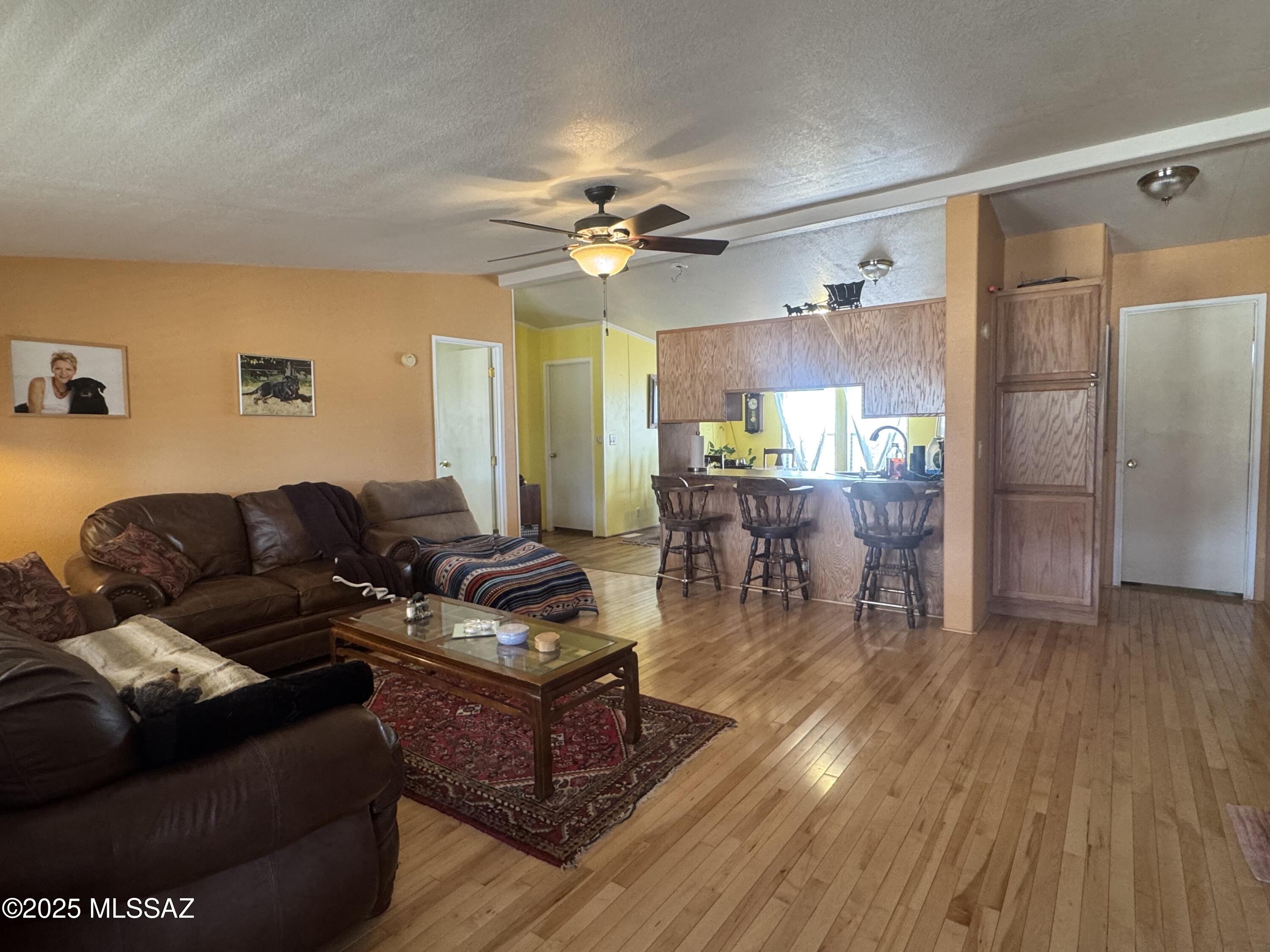 12440 South Coleman Road Tucson, AZ 85735 - Photo 16 of 45 a living room with furniture and a wooden floor