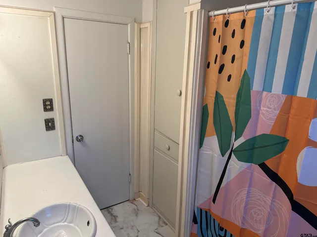 a bathroom with sink and shower