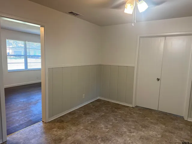 an empty room with a empty space and windows