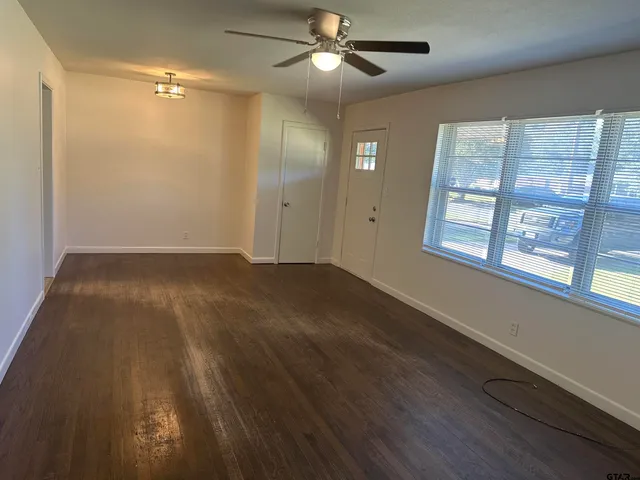 wooden floor in an empty room with a window
