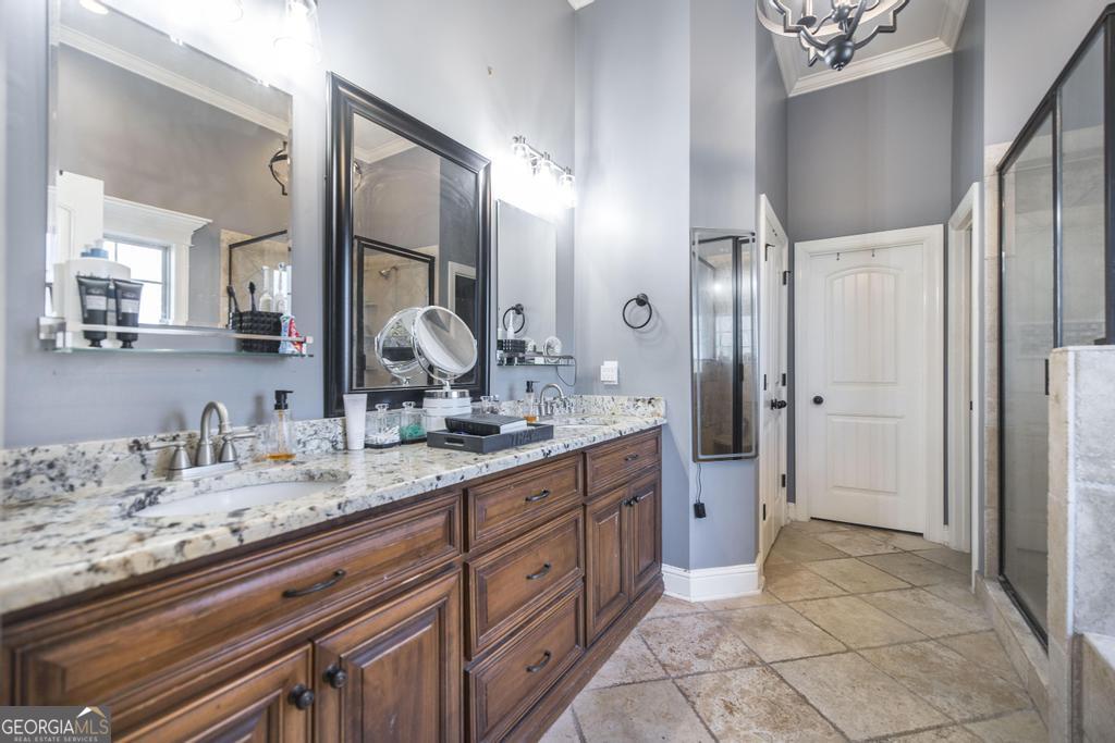 4065 Gordon Road Abbeville, GA 31001 - Photo 22 of 48 a spacious bathroom with a granite countertop sink a mirror and a shower
