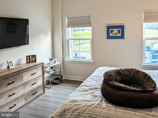 a bedroom with a bed and window