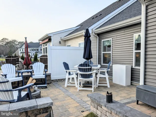 a view of a patio with dining table and chairs