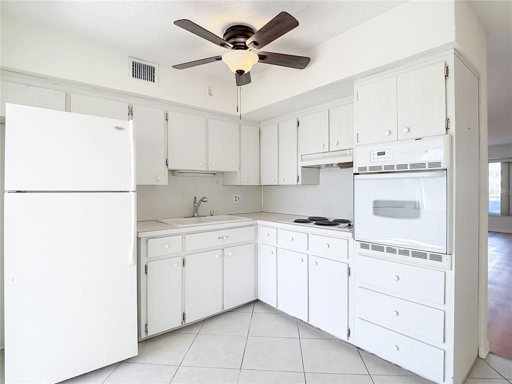 2461 Canadian Way, Unit 45 Clearwater, FL 33763 - Photo 11 of 33 a kitchen with cabinets stainless steel appliances and a refrigerator