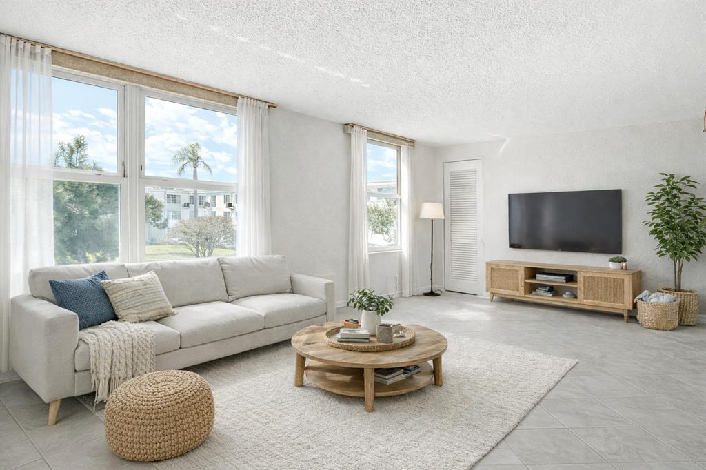 2461 Canadian Way, Unit 45 Clearwater, FL 33763 - Photo 13 of 33 a living room with furniture and a flat screen tv