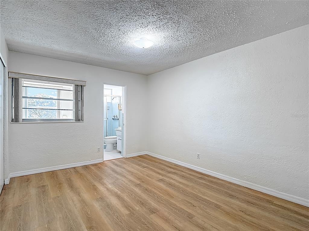 2461 Canadian Way, Unit 45 Clearwater, FL 33763 - Photo 18 of 33 a view of empty room with wooden floor and fan