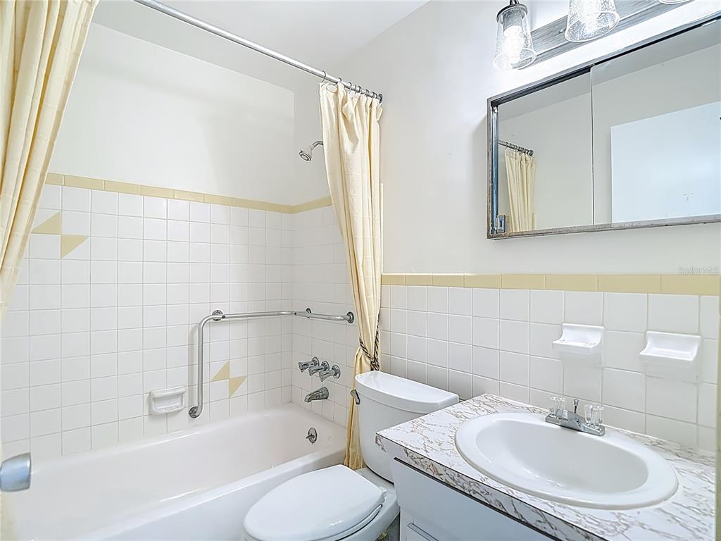 2461 Canadian Way, Unit 45 Clearwater, FL 33763 - Photo 25 of 33 a bathroom with a sink toilet and shower